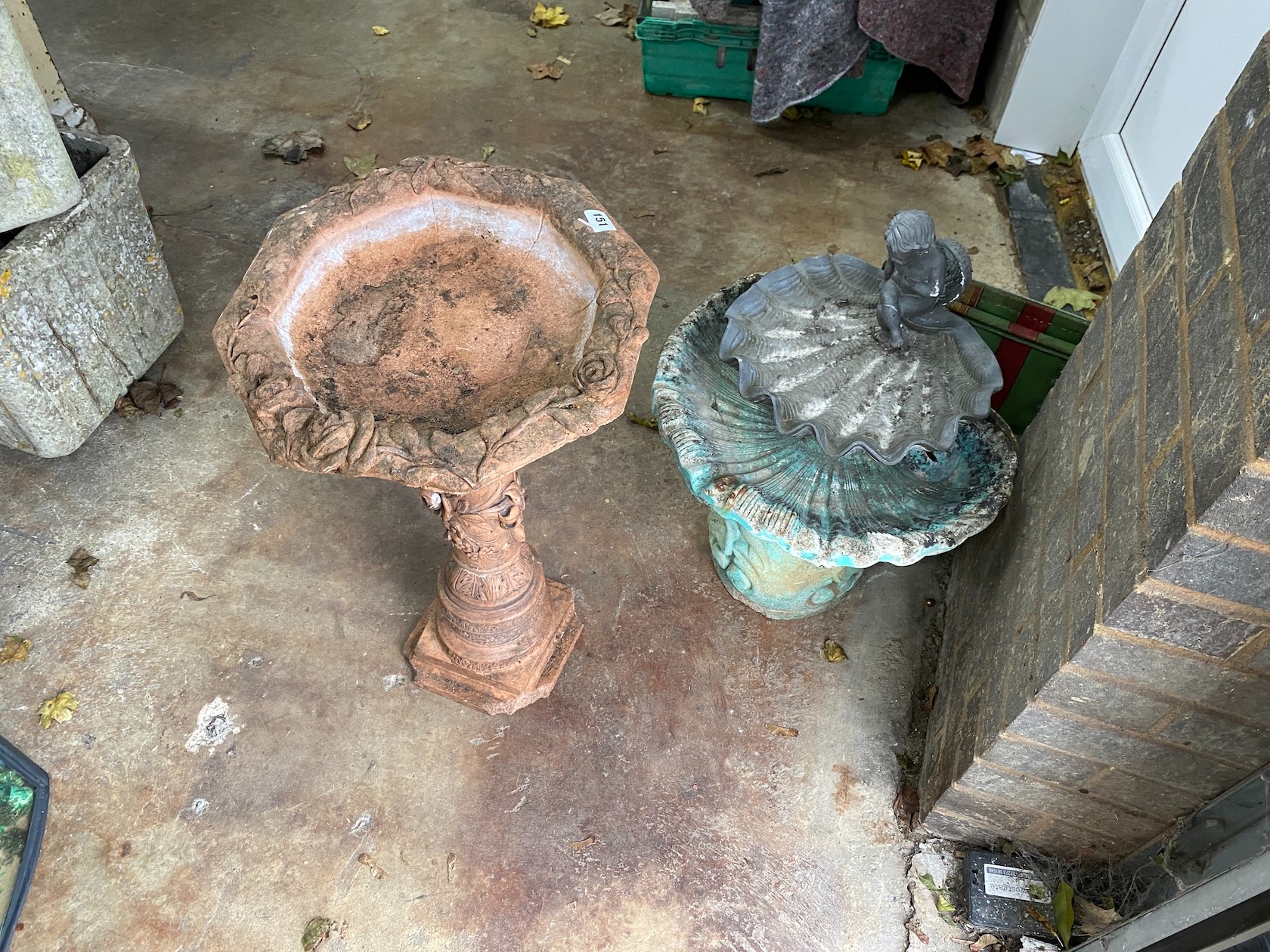 Three stone and composition bird baths, largest height 67cm and two canvas folding stools